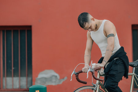 young man with bicycle on the streetの写真素材