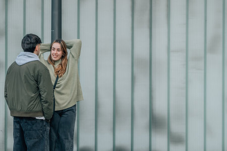 urban young romantic couple on the street flirting or talkingの写真素材