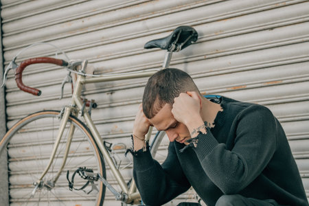 young man sitting on the street with problem expression