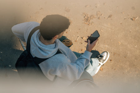 top view of a young man with bicycle and mobile phoneの写真素材