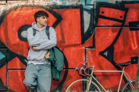 young man on street wall with vintage bicycle and copy-spaceの写真素材