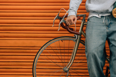 student with vintage bicycle and young american outfitの写真素材