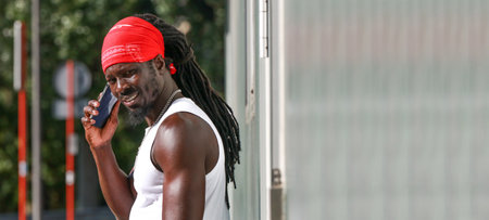 young african man on the street talking on mobile phoneの写真素材