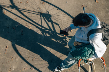 top view of a young man with bicycle and mobile phone