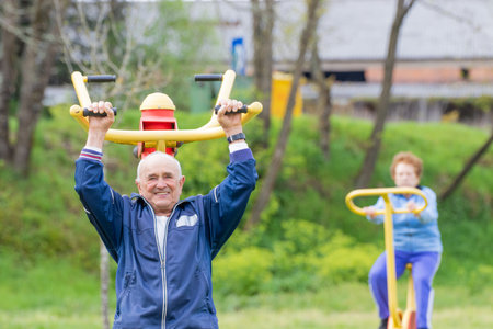senior couple practicing exercise outdoors