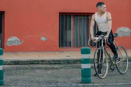 young man with bicycle on the streetの写真素材