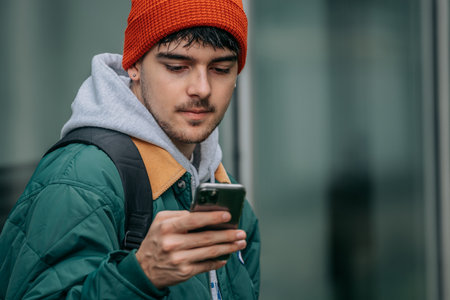 young man with mobile phone on the street