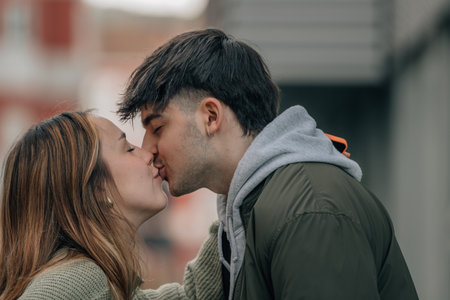 Young couple kissing in the city. Man and woman in love.の写真素材