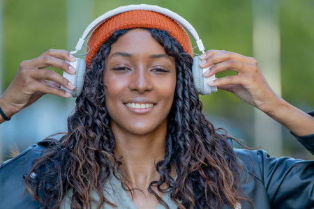 young woman or young girl with headphones outdoorsの写真素材