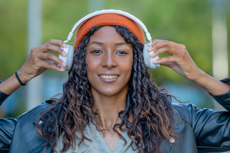 young woman or young girl with headphones outdoorsの写真素材