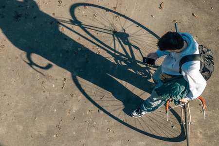 top view of a young man with bicycle and mobile phoneの写真素材