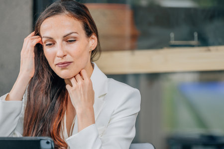 business woman looking at laptop at cafe terrace tableの写真素材
