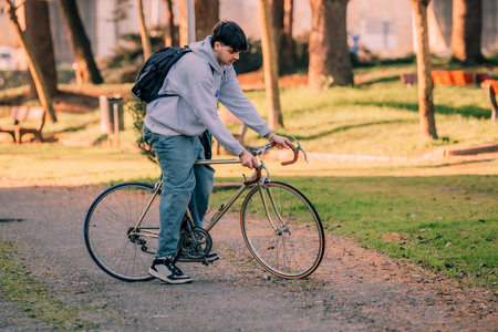 young man on the street riding on vintage bicycle