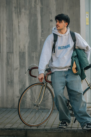 urban scene of young man with vintage bicycle