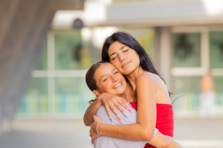 friends hugging smiling and happy on the streetの写真素材