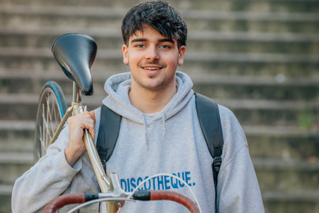 student carrying the bicycle
