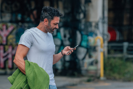 young man on the street with mobile phoneの写真素材