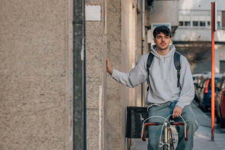 student on the street riding a vintage bicycleの写真素材