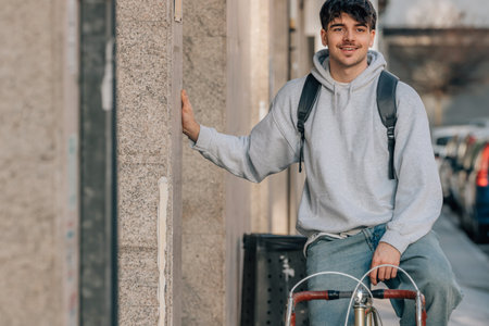 student on the street riding a vintage bicycleの写真素材