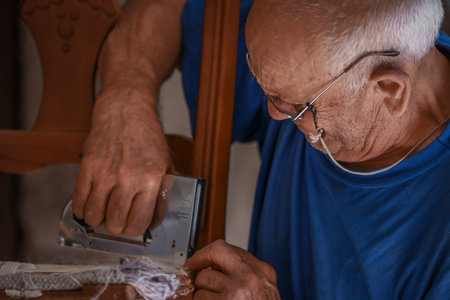 upholsterer craftsman working in the workshop