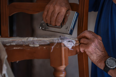 upholsterer craftsman working in the workshopの写真素材