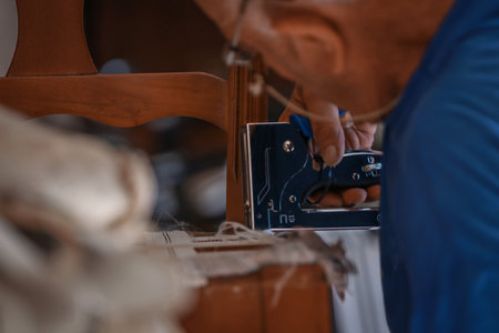 upholsterer craftsman working in the workshopの写真素材
