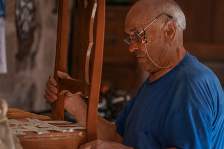 upholsterer craftsman working in the workshopの写真素材