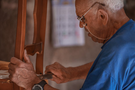 upholsterer craftsman working in the workshopの写真素材
