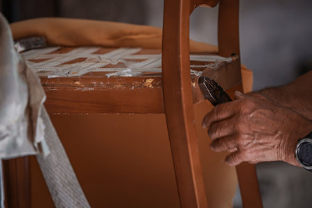 upholsterer craftsman working in the workshopの写真素材