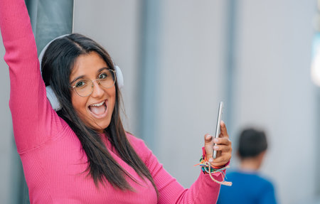 girl on the street with headphones and mobile phone