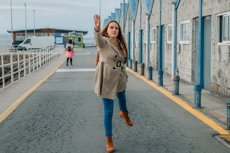 woman on the street with an expression of runningの写真素材