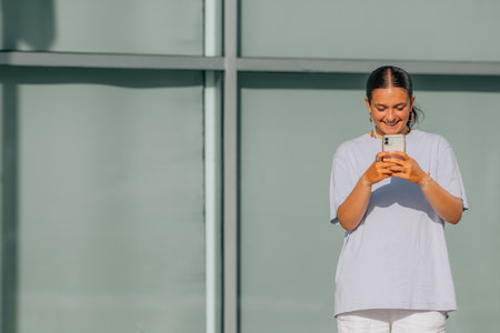 girl on the street in summer looking at mobile phone