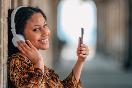 young latina woman with headphones and mobile phoneの写真素材