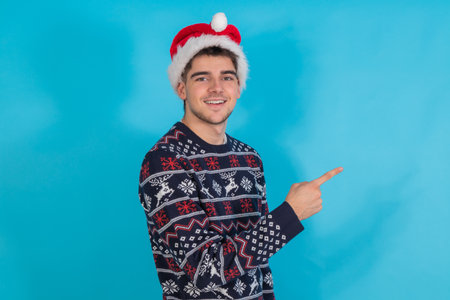 young man in christmas outfit isolated on color backgroundの写真素材