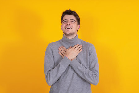 isolated young man or teenager with expression of desire or dreamの写真素材