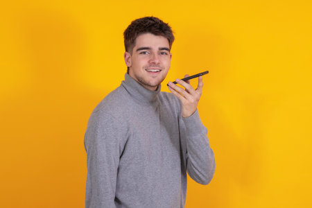 isolated young man with mobile phoneの写真素材