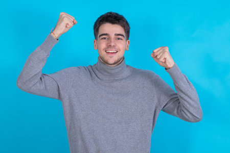 young man isolated on background celebrating euphoricの写真素材