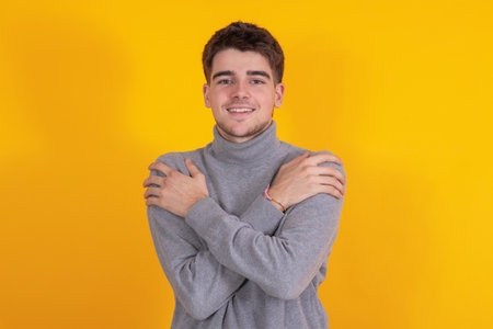 isolated young man hugging smilingの写真素材