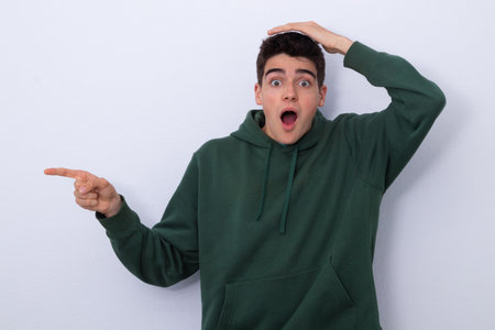 isolated young man pointing surprisedの写真素材