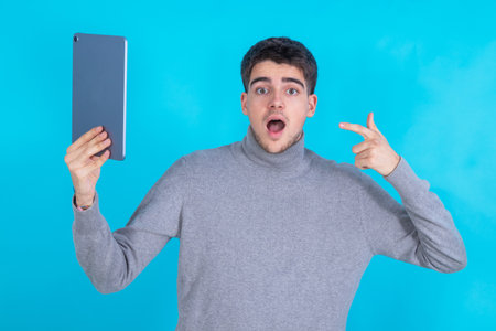 isolated young man with tablet or laptop