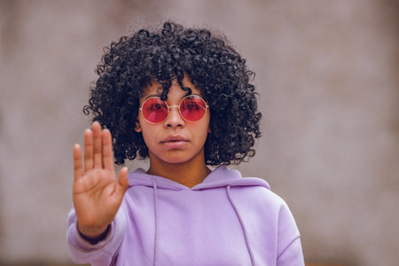 feminist woman with hand in front in stop signの写真素材