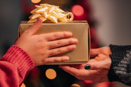 hands giving gifts at christmas with familyの写真素材