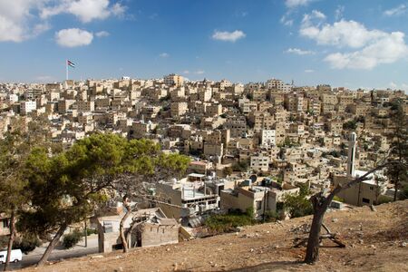 Panoramic view of the city of Amman with Jordanian flags of the royal palace in the backgroundの写真素材