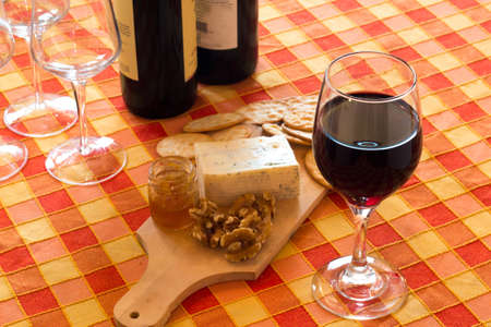 Wine tasting with cheese and honey walnutsの写真素材