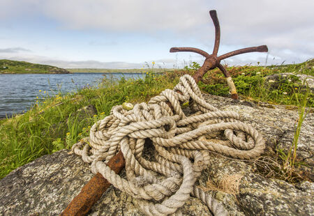 old rusty anchor with rope, St. Anthony, Newfoundlandの写真素材