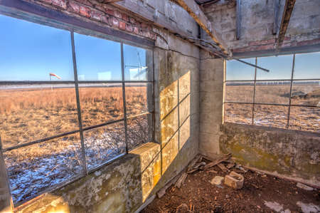 abandoned office building at rural Kansas airstrip; windsockの写真素材
