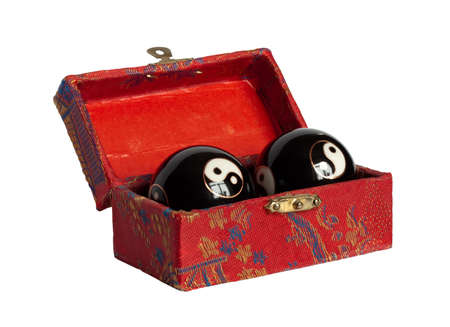 Handmade Chinese casket with two yin yan balls isolated on the white background.の写真素材