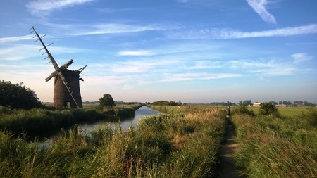 Landscape of Horsey windmill on the Norfolk Broads with manの写真素材