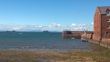 View out to sea on a bright Summer Day in North Berwick Scotland United Kingdom from the sand and sea weed beachの写真素材