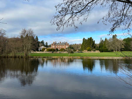 "Thetford, Norfolk / England uk - January 3 2022: Landscape view of Lyndford Hall Country house mansion arboretum lake water trees reflected historic building 'Hello Hello' television series filmed"のeditorial素材